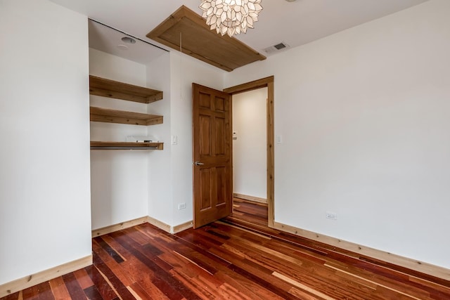 unfurnished bedroom with dark hardwood / wood-style floors