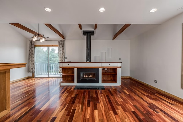 unfurnished living room with wood-type flooring and beam ceiling