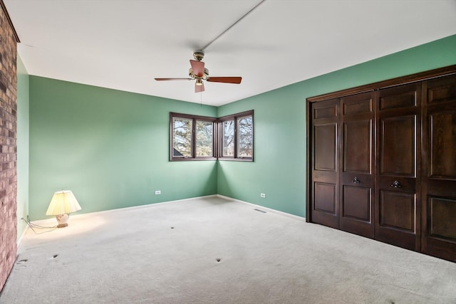 unfurnished bedroom with light colored carpet, ceiling fan, and a closet