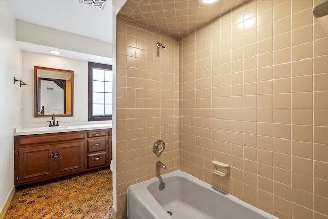 bathroom with vanity and tiled shower / bath combo