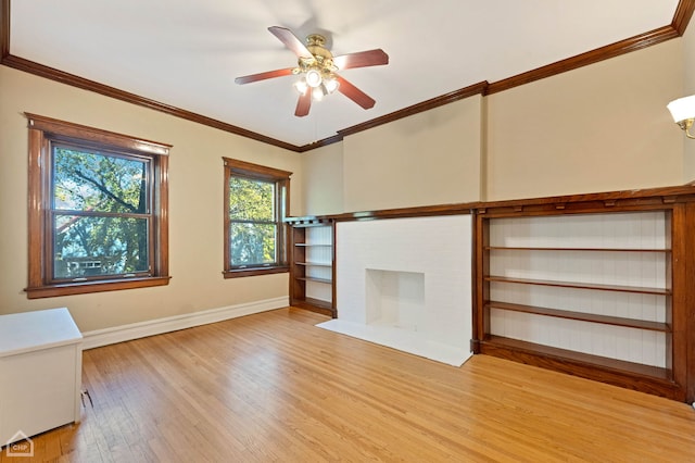 unfurnished living room with ornamental molding, ceiling fan, a fireplace, and light hardwood / wood-style flooring