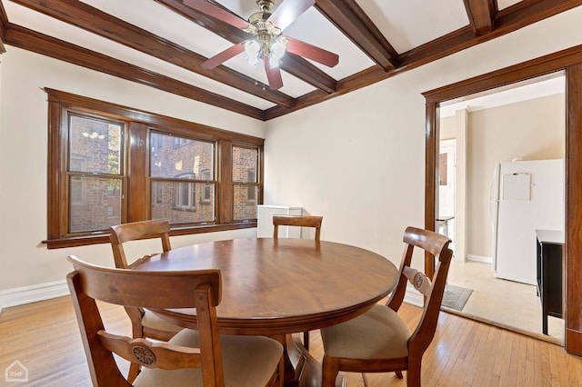 dining space with ceiling fan, beam ceiling, and light wood-type flooring