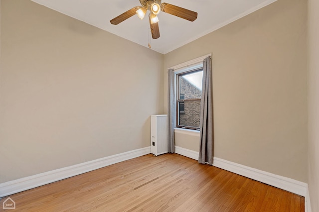 spare room featuring ceiling fan and light hardwood / wood-style flooring