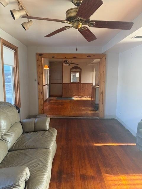 unfurnished living room with dark hardwood / wood-style floors and ceiling fan