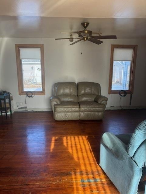 living room with ceiling fan and dark hardwood / wood-style flooring