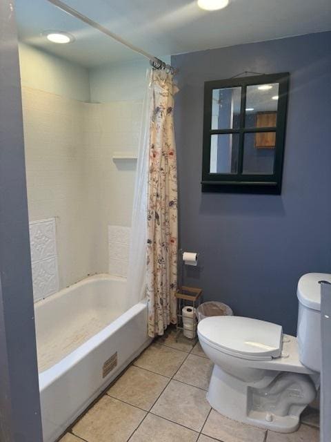 bathroom with tile patterned floors, shower / bath combination with curtain, and toilet