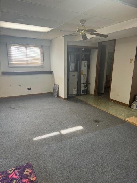 carpeted empty room with water heater and ceiling fan