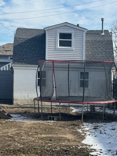 view of snowy exterior featuring a trampoline