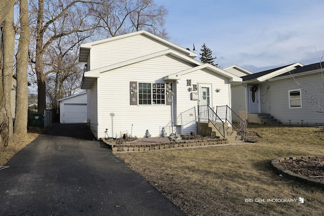 view of front of property featuring a garage and an outdoor structure