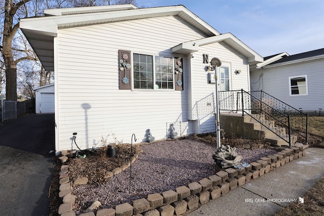 view of front facade featuring an outbuilding and a garage