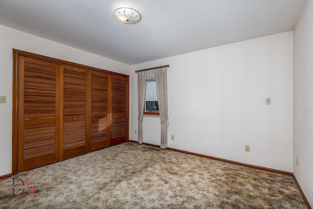 unfurnished bedroom with carpet floors and a closet