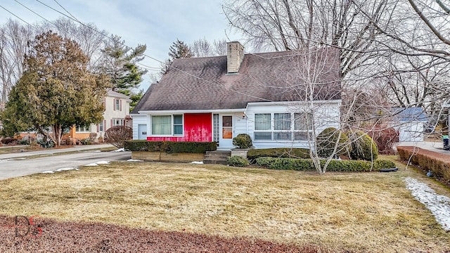 cape cod-style house with a front lawn