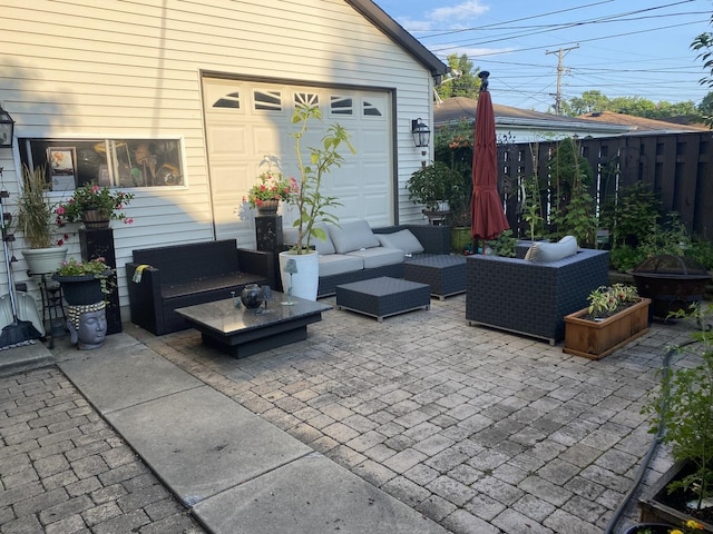 view of patio / terrace featuring a garage and an outdoor hangout area