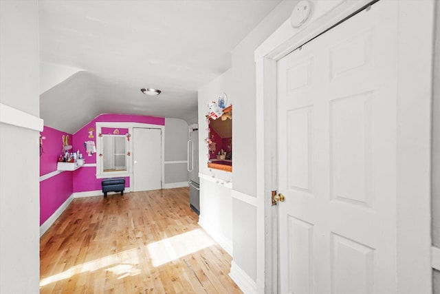 interior space featuring lofted ceiling and wood-type flooring