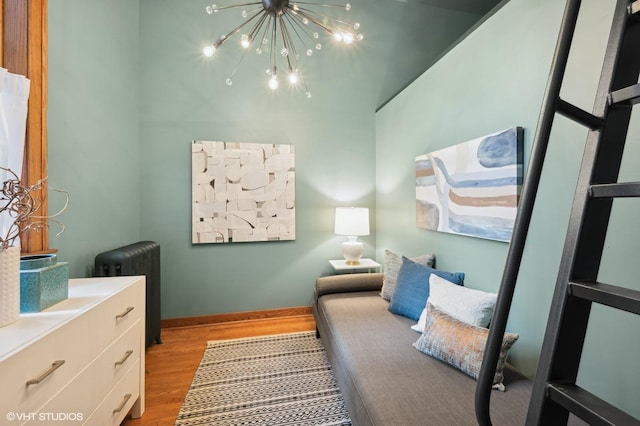 bedroom featuring light hardwood / wood-style flooring and a notable chandelier