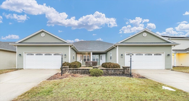 ranch-style home with a garage and a front lawn