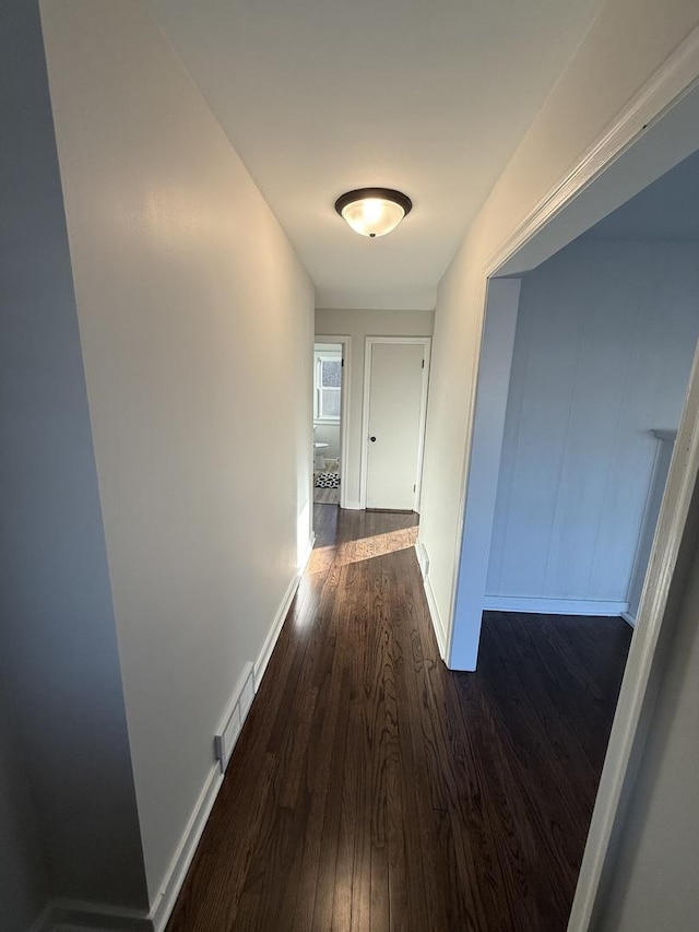 corridor featuring dark wood-type flooring