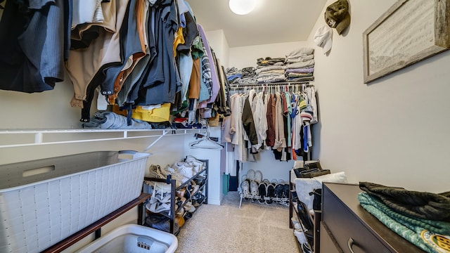 walk in closet featuring light colored carpet