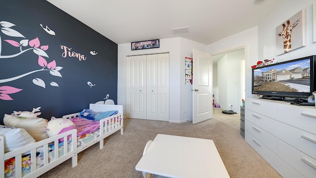 bedroom featuring light carpet and a closet