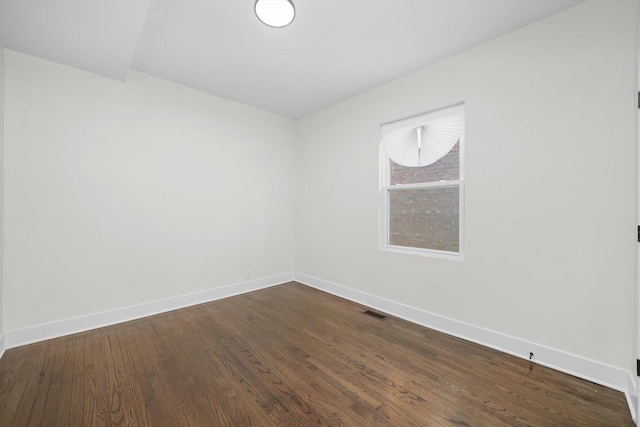 spare room with wood-type flooring