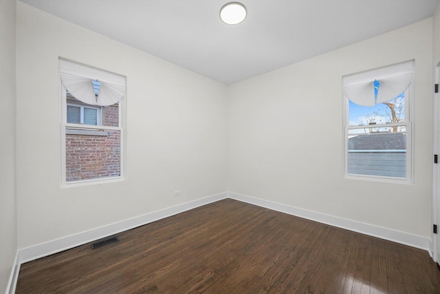 empty room featuring dark wood-type flooring