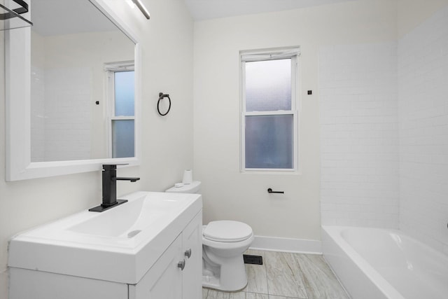 full bathroom featuring tiled shower / bath combo, vanity, and toilet