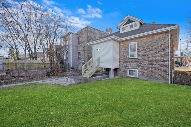 rear view of house featuring a lawn