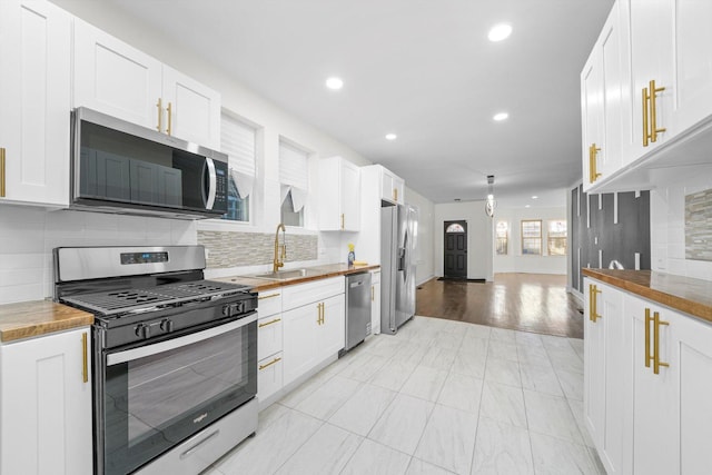 kitchen with white cabinetry and appliances with stainless steel finishes