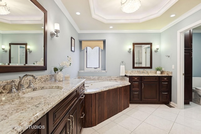 bathroom with vanity, ornamental molding, toilet, a raised ceiling, and tile patterned floors