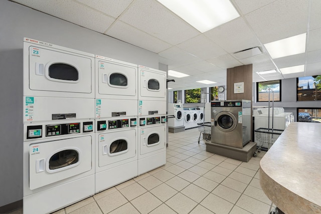 clothes washing area with stacked washer and clothes dryer and washing machine and clothes dryer