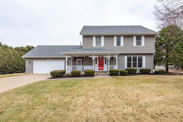 view of front of property with a garage, a front yard, and covered porch