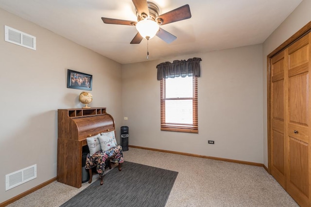 interior space featuring ceiling fan and carpet