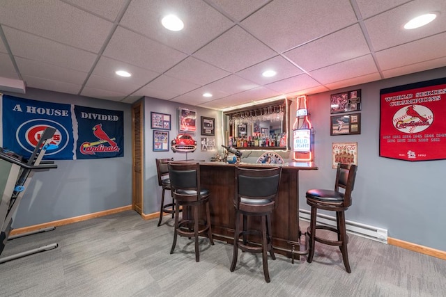 bar with a baseboard radiator, a paneled ceiling, and carpet