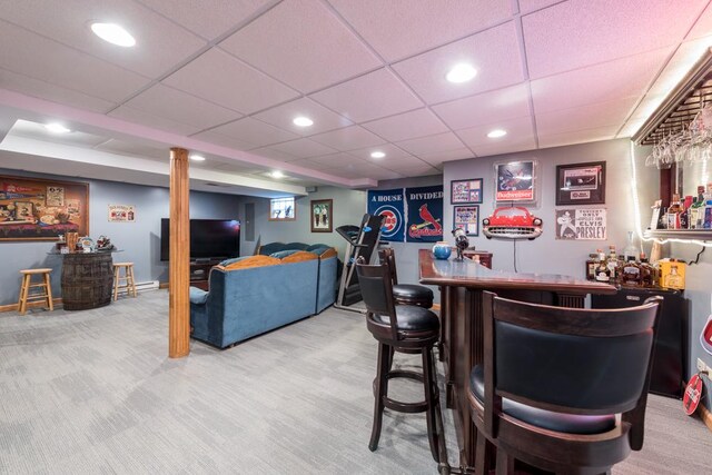 bar featuring a paneled ceiling and carpet