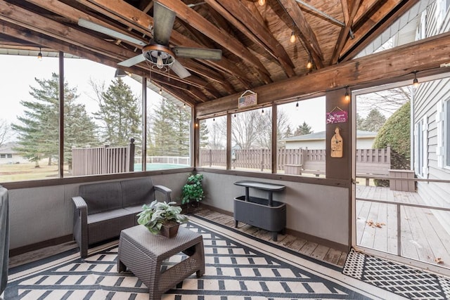 sunroom / solarium with lofted ceiling, a wealth of natural light, and ceiling fan