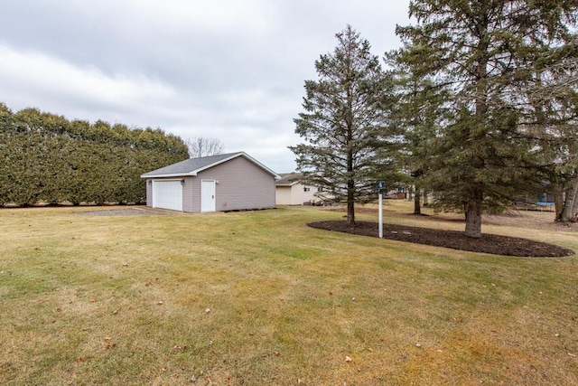 view of yard with an outbuilding and a garage