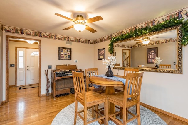 dining space with light hardwood / wood-style floors and ceiling fan