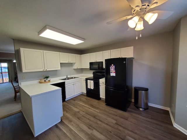 kitchen with dark wood-type flooring, sink, black appliances, ceiling fan, and white cabinets