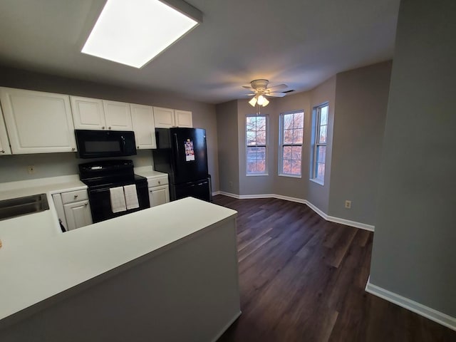 kitchen featuring white cabinetry, sink, kitchen peninsula, and black appliances