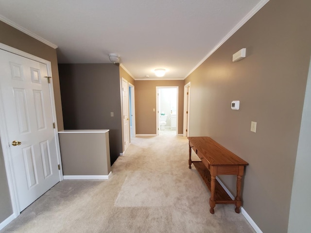 hall with crown molding and light colored carpet