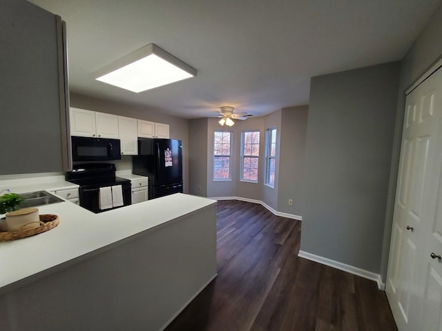 kitchen with sink, black appliances, white cabinets, dark hardwood / wood-style flooring, and kitchen peninsula