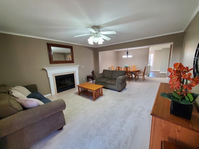 carpeted living room with ceiling fan, ornamental molding, and a tile fireplace