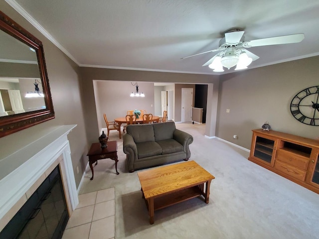 living room with crown molding, ceiling fan with notable chandelier, and light colored carpet