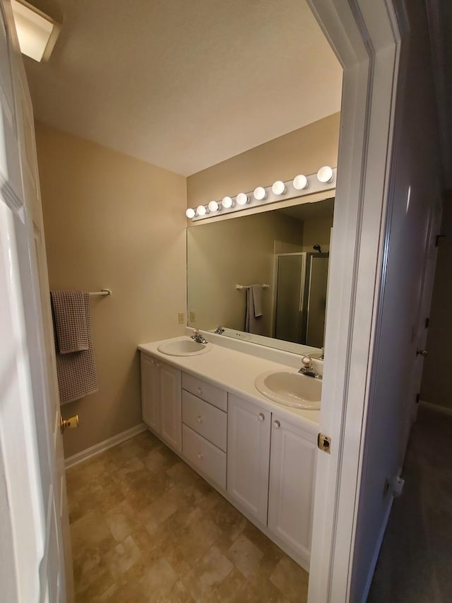 bathroom featuring vanity and an enclosed shower