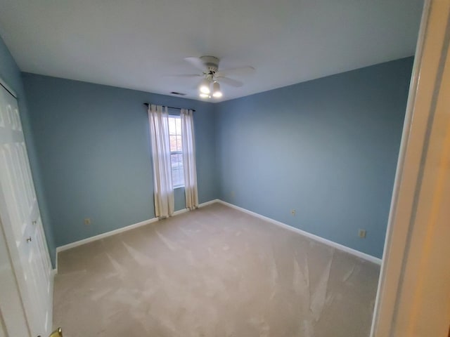 empty room featuring carpet and ceiling fan