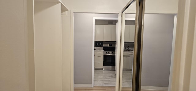 interior space with sink and light hardwood / wood-style flooring