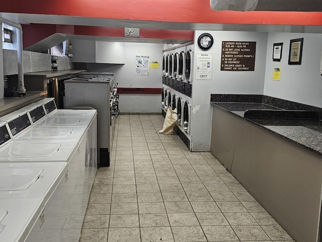 kitchen featuring dark stone counters and washing machine and dryer