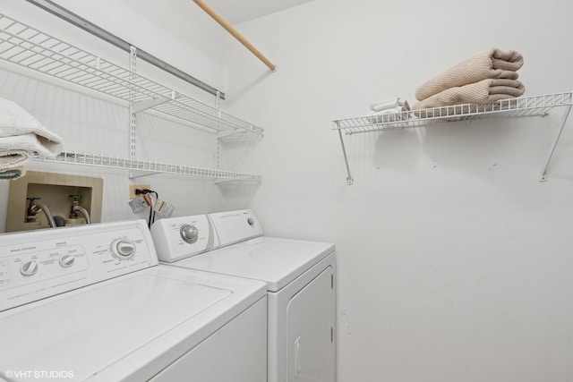 clothes washing area with separate washer and dryer