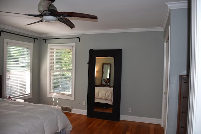 bedroom with ornamental molding, hardwood / wood-style floors, and ceiling fan