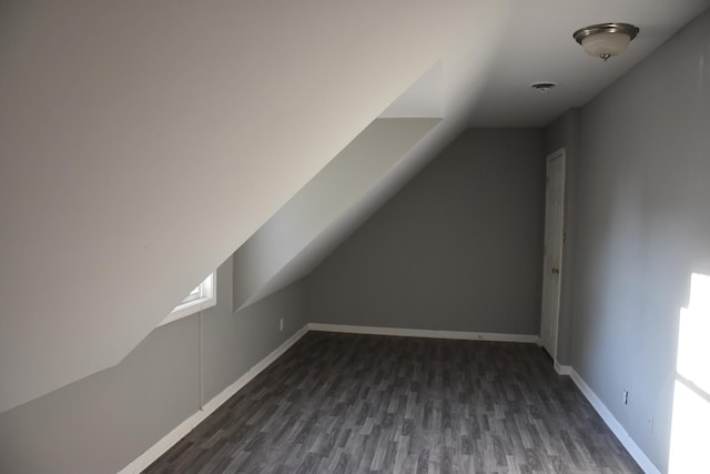 bonus room featuring dark hardwood / wood-style flooring and vaulted ceiling